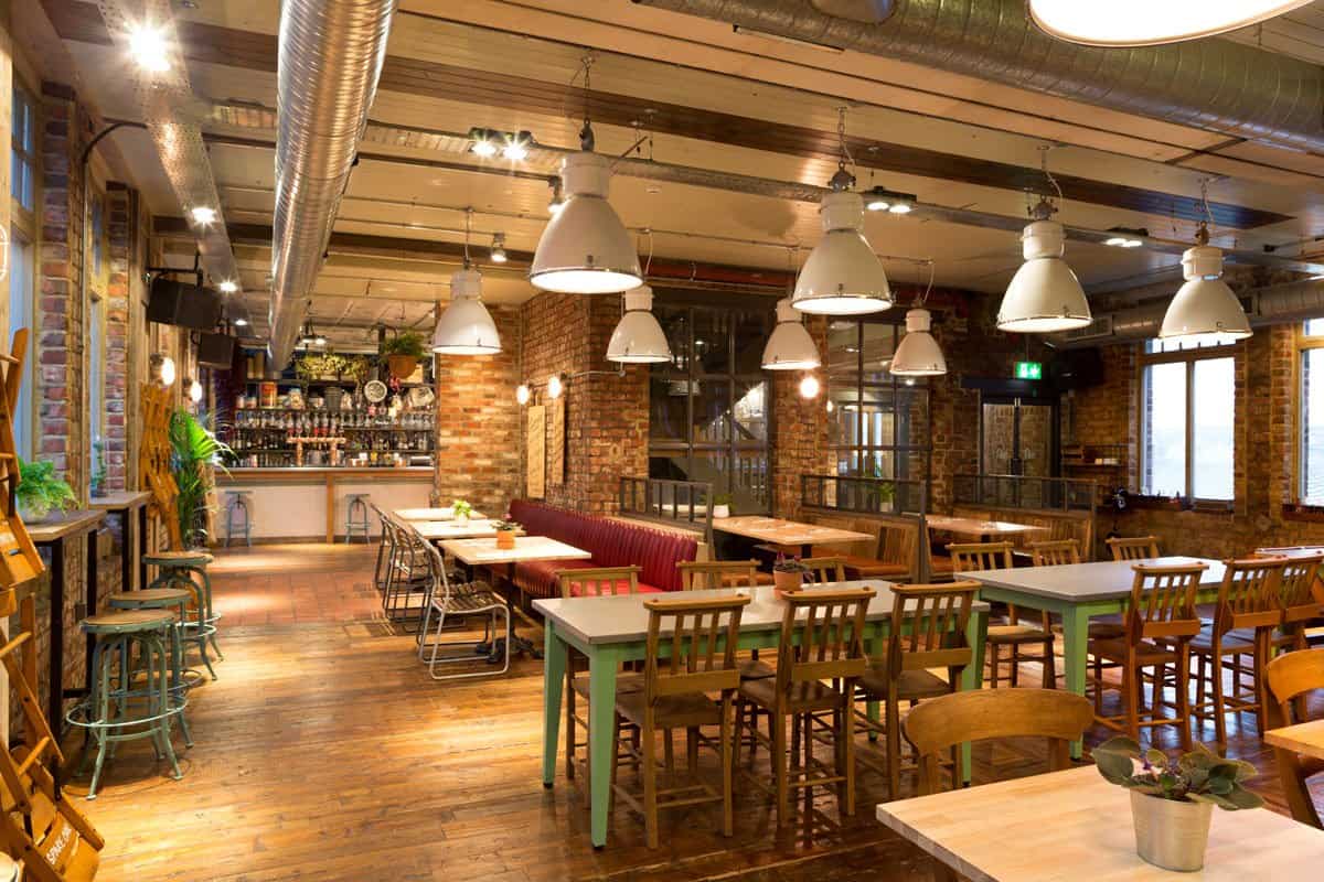 Commercial restaurant interior with installed lighting and electrical infrastructure.