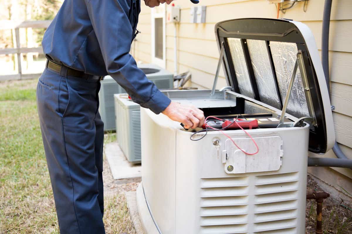 Technician testing a standby generator during installation and system inspection.