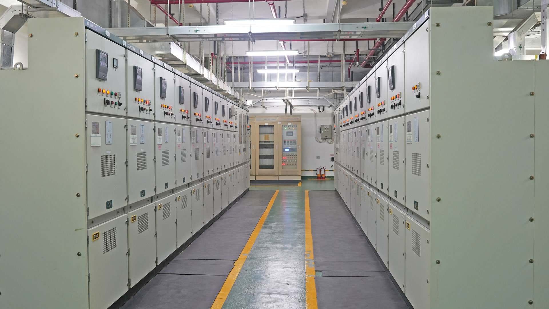 Industrial electrical switchgear panels inside a facility power distribution control room.